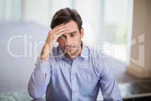 Worried businessman with hand on head