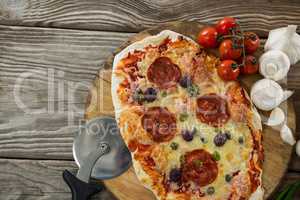 Various species with pizza and tomato on a wooden tray