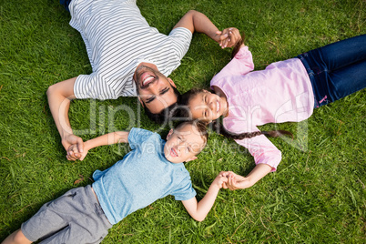 Father having fun with his son and daughter in park