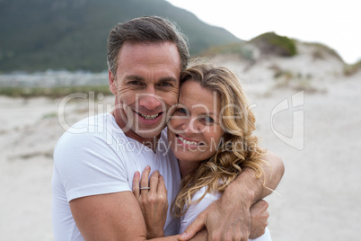 Mature couple embracing each other on the beach