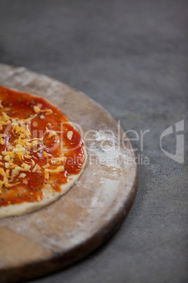 Pizza dough with tomato sauce with grated cheese