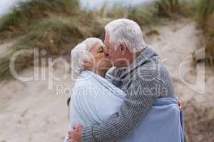 Senior man kissing senior woman