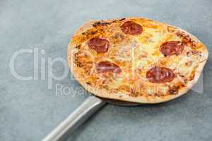 Italian pizza placed on a spatula