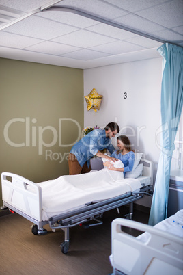 Couple with their new born baby in the ward
