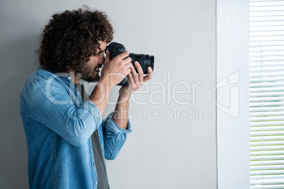 Photographer with digital camera in studio