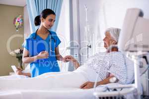 Female doctor examining senior woman