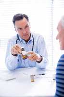 Doctor explaining medicine to senior patient