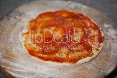 Pizza dough with tomato sauce