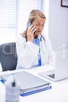 Female doctor talking on mobile phone