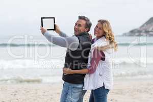 Mature couple taking selfie with digital tablet