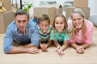 Parents and kids lying on floor in living room