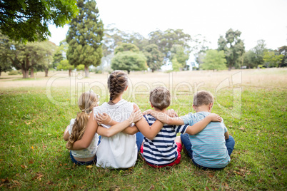 Kids sitting together in park