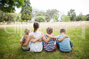 Kids sitting together in park