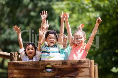 Kids standing on a playground ride in park