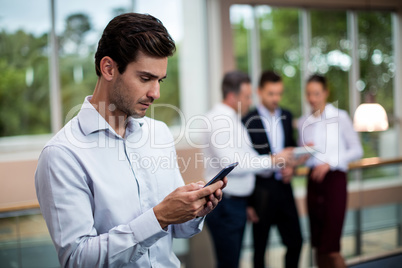 Male business executive using mobile phone