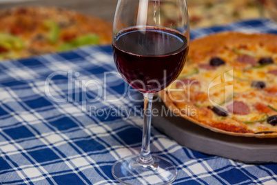 Delicious pizza with a glass of red wine