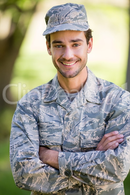 Portrait of soldier standing with arms crossed in park