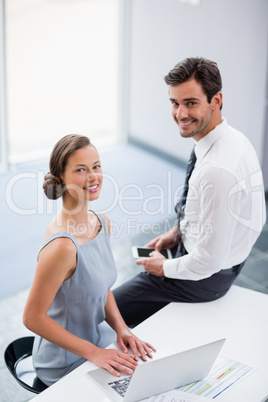 Business executives with laptop at conference centre