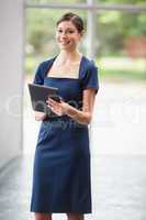 Confident and beautiful business executive holding digital tablet