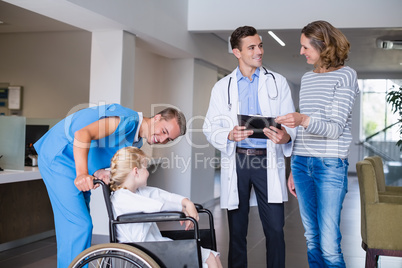 Doctor discussing medical report with mother