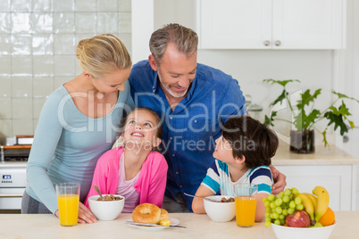 Happy family having breakfast in kitchen