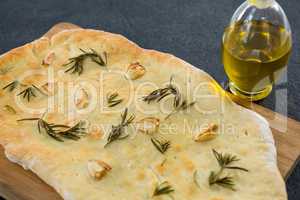 Italian pizza with olive oil on a chopping board