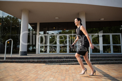 Businesswoman running outside the conference centre