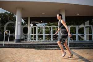 Businesswoman running outside the conference centre