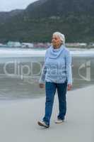 Senior woman walking on the beach