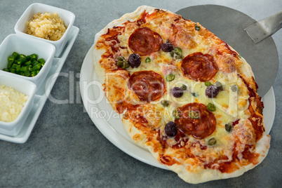 Italian pizza being served on a plate