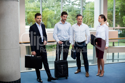 Business executives interacting in a conference center lobby