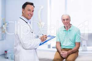 Portrait of smiling doctor and senior patient