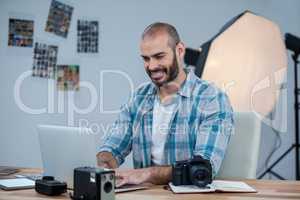 Photographer working over laptop