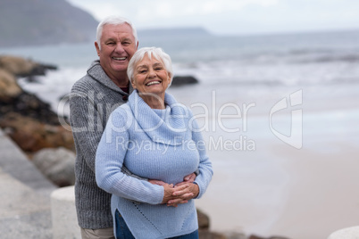 Senior couple embracing each other on the beach