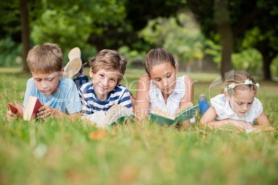 Kids lying on grass and reading books