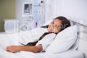 Sick girl lying in hospital bed