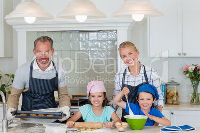 Parents and kids preparing food in kitchen