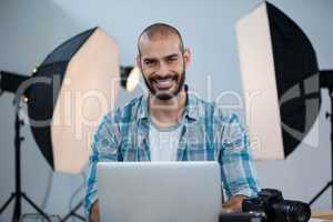 Photographer working over laptop