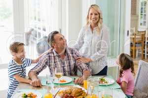 Family having meal on dinning table at home