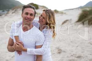 Mature couple standing together on the beach
