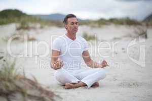 Mature man doing meditation