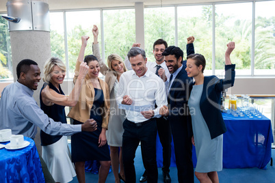 Happy business executives looking at report