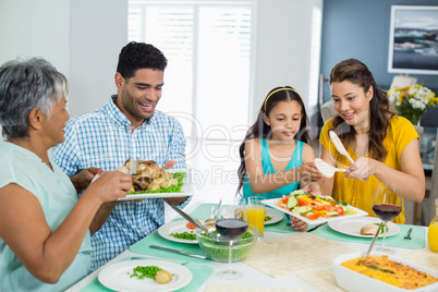 Happy multi generation family having meal on table