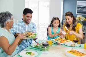 Happy multi generation family having meal on table