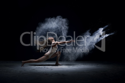 Contemporary dancer performing  in cloud of powder