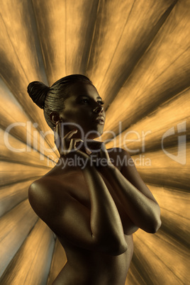 Naked model with golden trendy makeup and bodyart