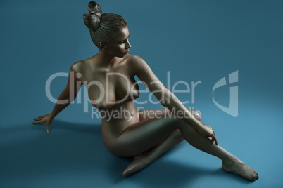 Naked model covered with silver bodyart paint