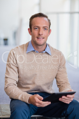 Portrait of a businessman holding digital tablet