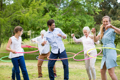 Multi-generation family playing with hula hoop