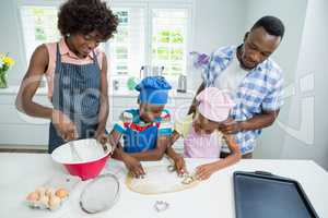 Parents and kids preparing food in kitchen